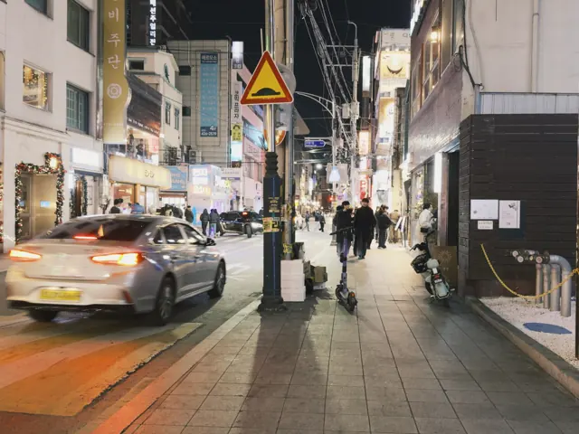 Evening lights and a taxi on a street in Daegu