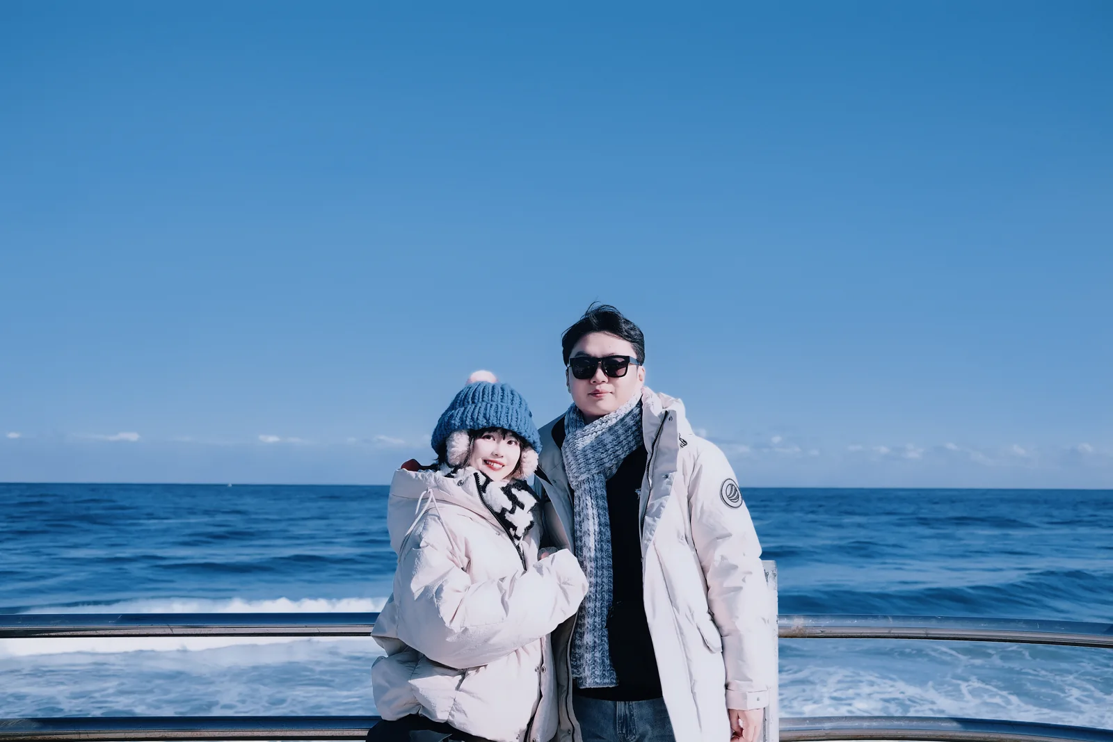 Kiwi and Jason smiling together at the blue coast of Gangneung