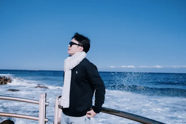 Jason enjoying the winter sunshine beside the waves
